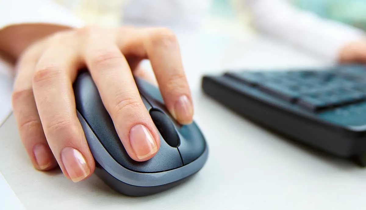 Close up on female hand using computer mouse